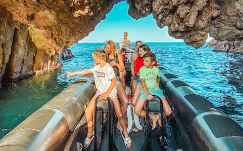 Family on boat tour exploring Esterel National Park's hidden coves.