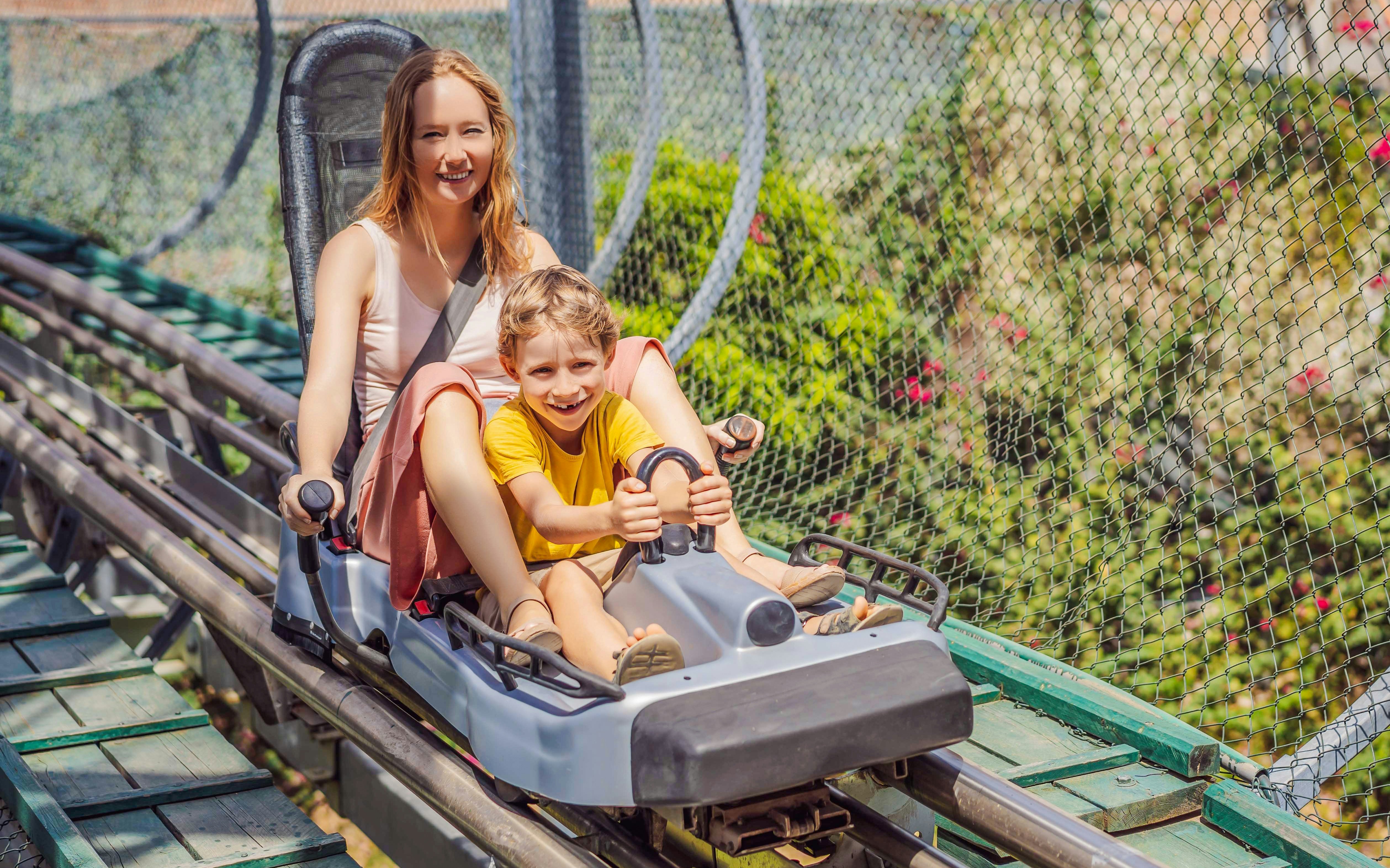 Friends enjoying Alpine Coaster ride at VinWonders Nha Trang Theme Park.