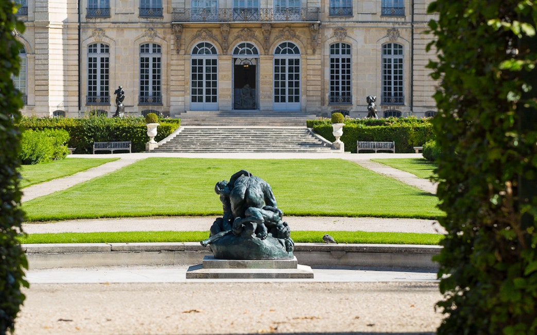 Rodin Museum garden with sculpture and historic building in Paris.