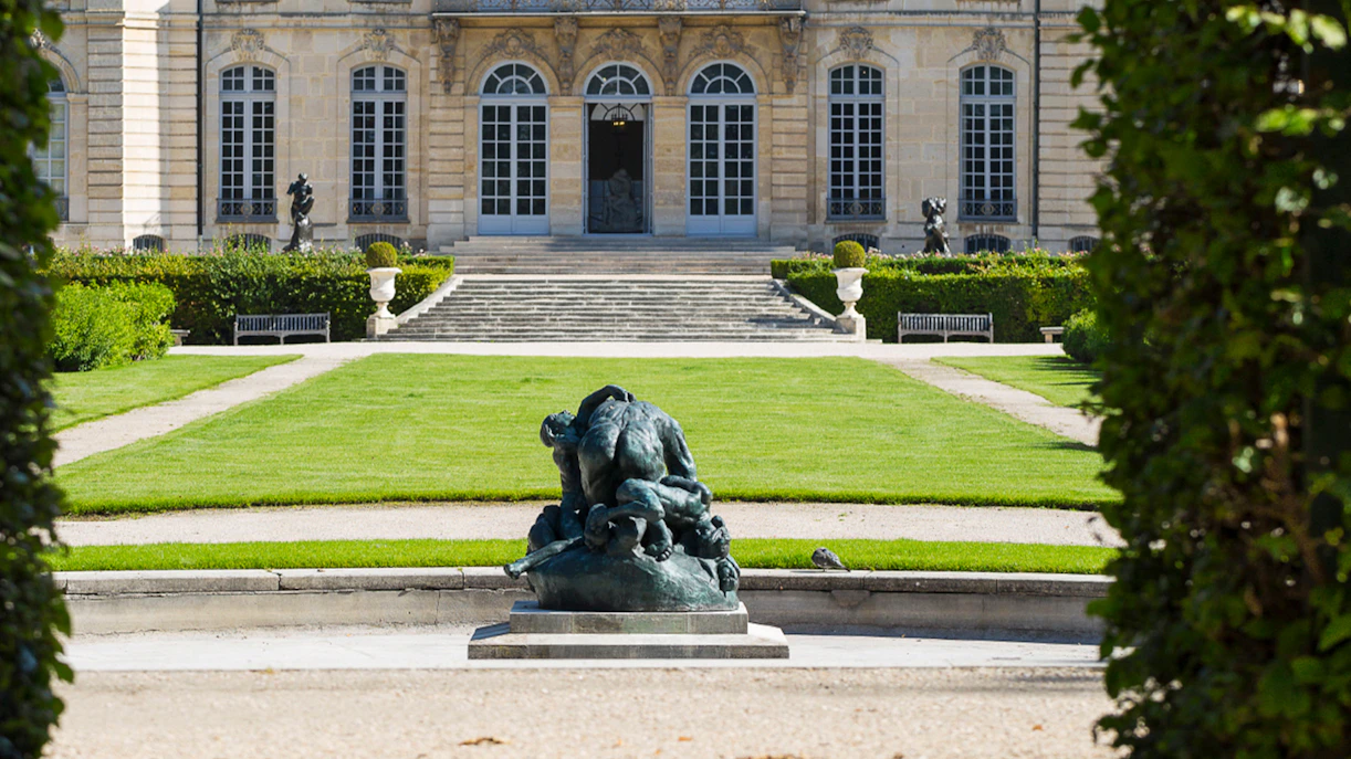 Rodin Museum garden with sculpture and historic building in Paris.
