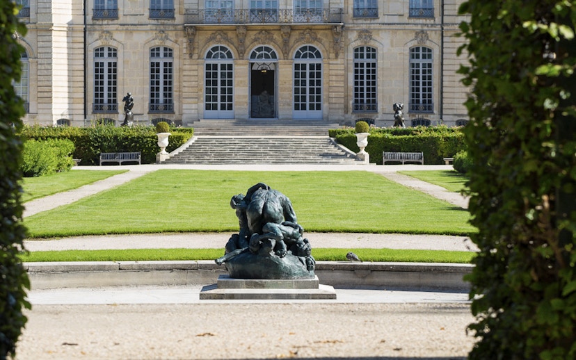 Rodin Museum garden with sculpture and historic building in Paris.