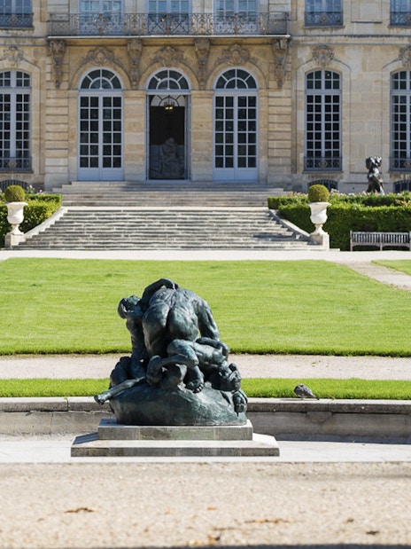 Rodin Museum garden with sculpture and historic building in Paris.