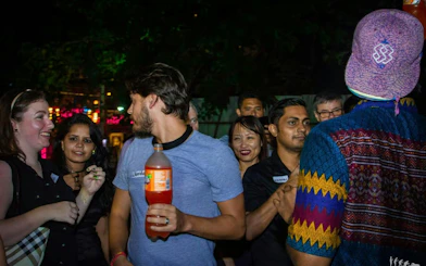 Group enjoying a nightlife pub crawl in Dubai with drinks and socializing.