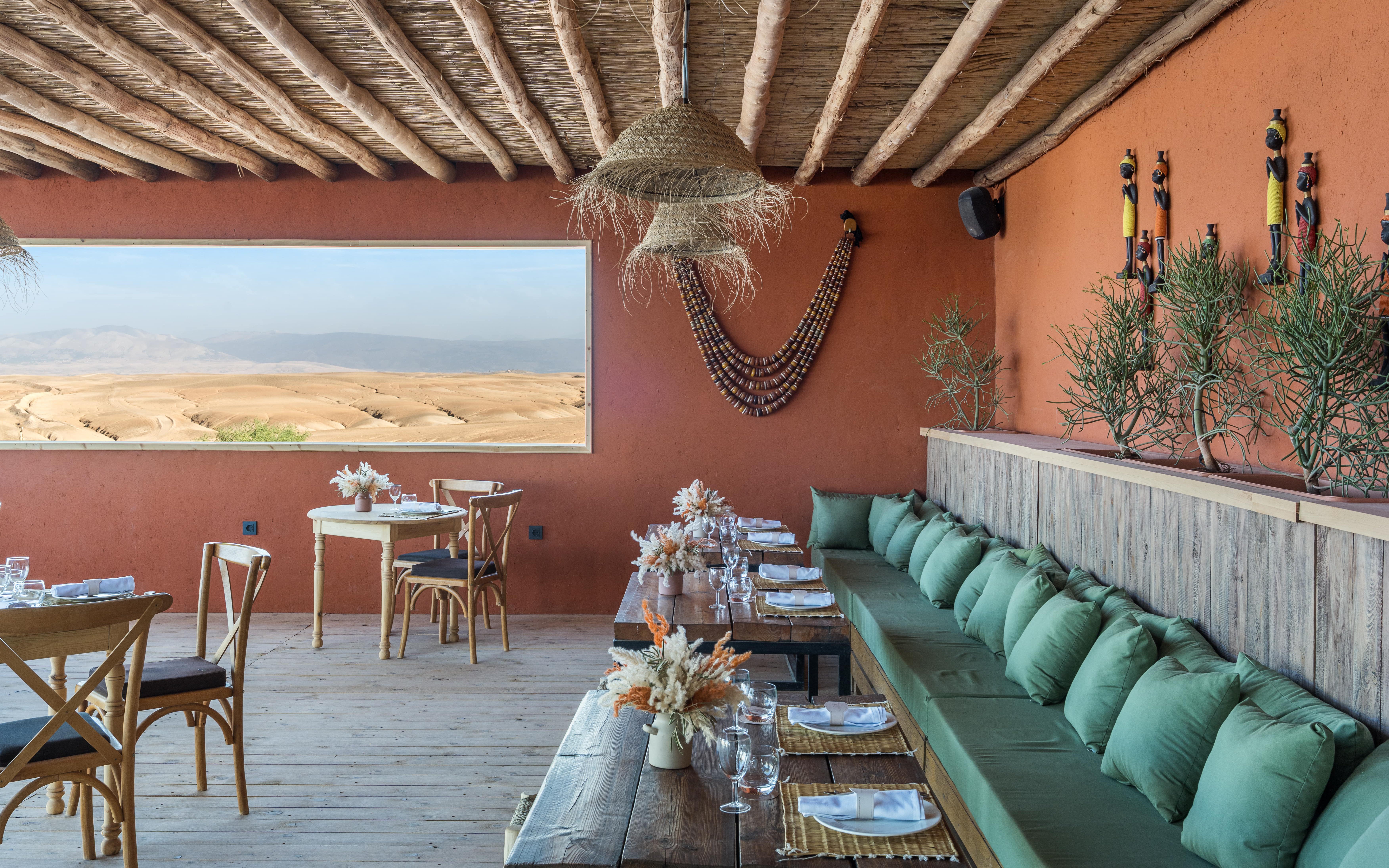Dining area with desert view at Les Terrasses d'Agafay camp, Morocco.