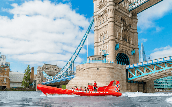 Speed boat on the Thames River near Tower Bridge, London.