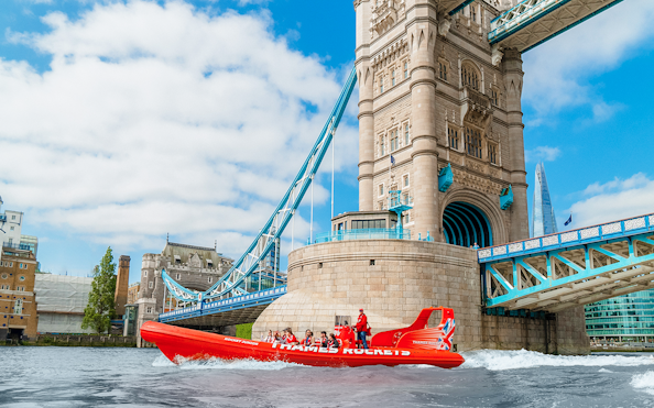 Speed boat on the Thames River near Tower Bridge, London.