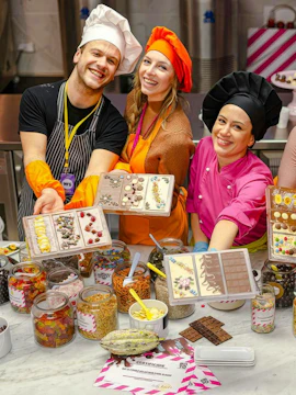 Participants in Vienna chocolate workshop displaying decorated chocolate bars.