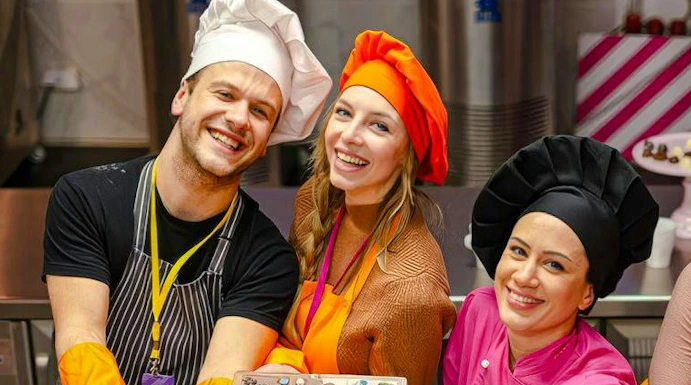 Participants in Vienna chocolate workshop displaying decorated chocolate bars.