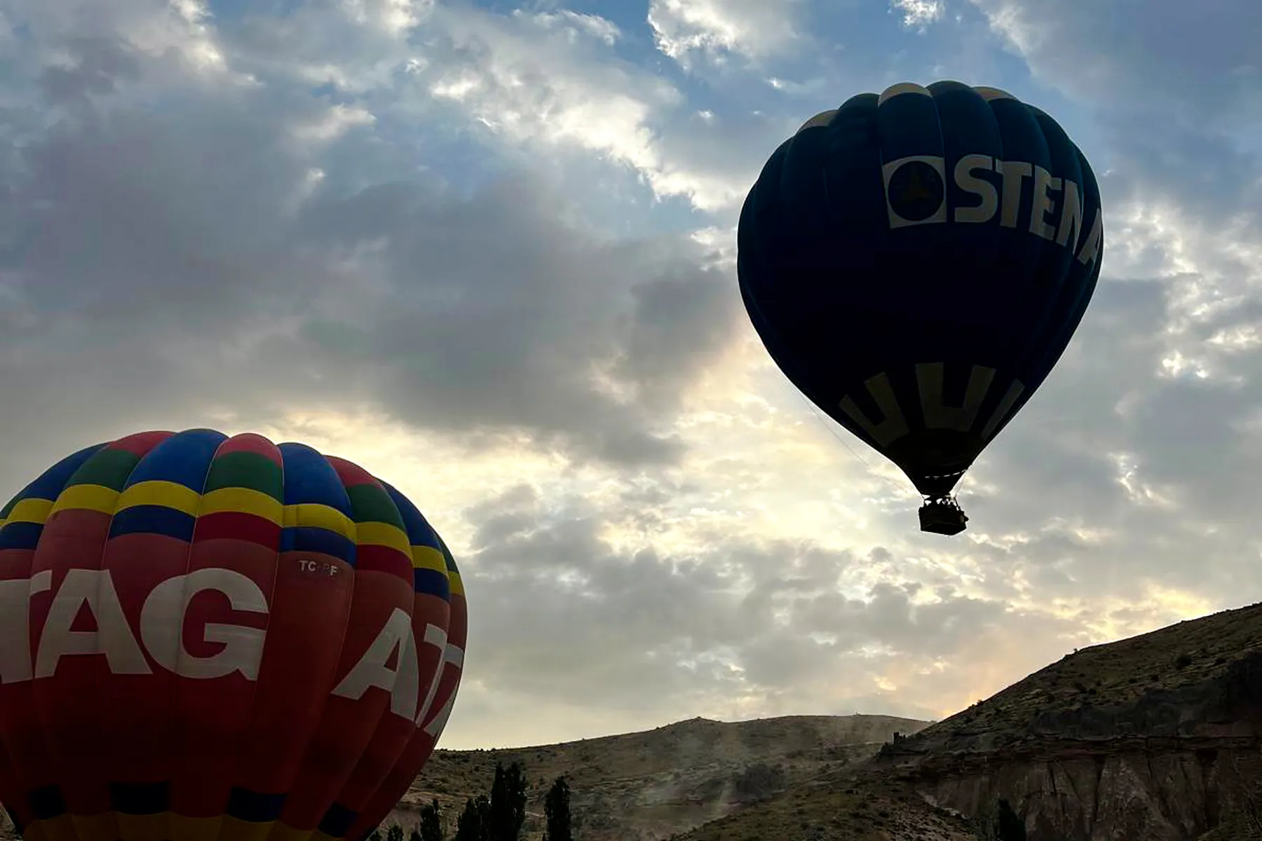 Hot air balloons floating over Ihlara Valley at sunrise, Cappadocia.