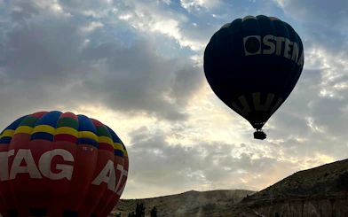 Hot air balloons floating over Ihlara Valley at sunrise, Cappadocia.