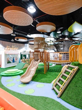 Indoor play area with slides and climbing structures at Orange Wheels, Global Village, Dubai.