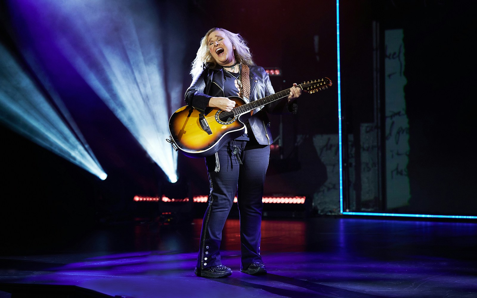 Musician performing on stage with a guitar during "Melissa Etheridge: My Window" show.