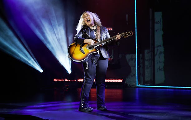 Musician performing on stage with a guitar during "Melissa Etheridge: My Window" show.