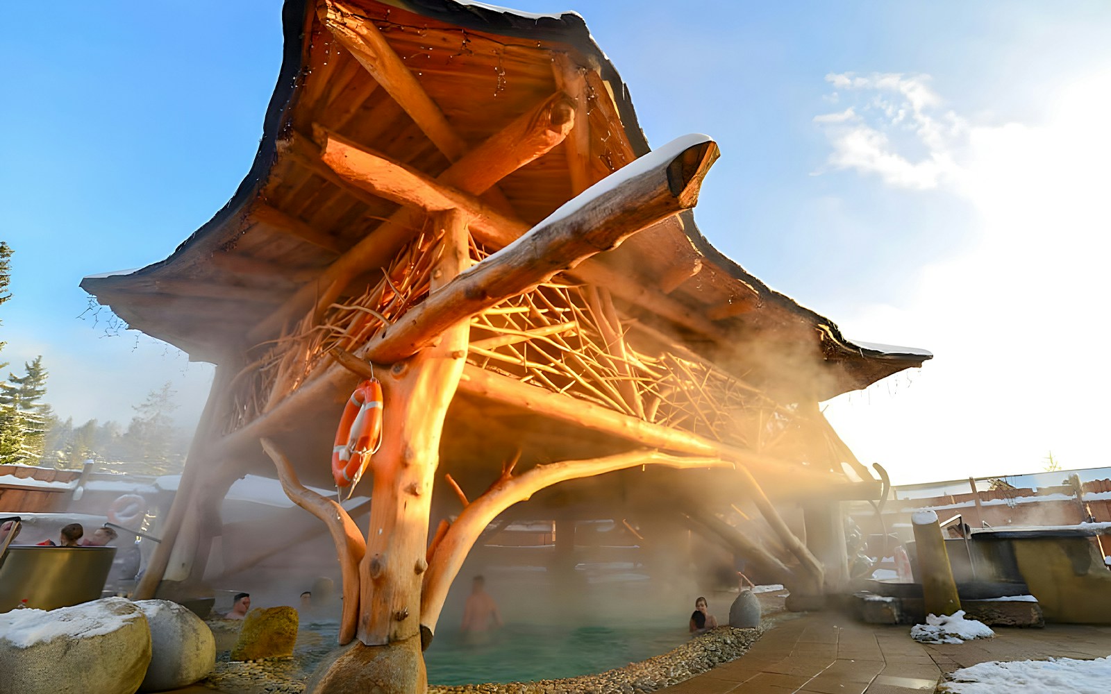 Goracy Potok Thermal Bath with wooden structure and steam rising, near Krakow.