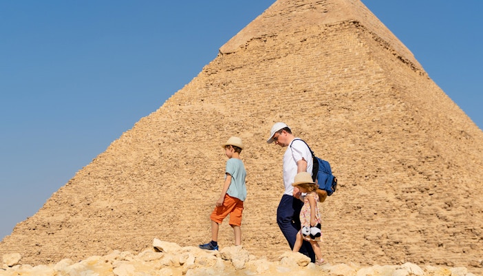 Family walking near the Pyramid of Giza, Egypt.