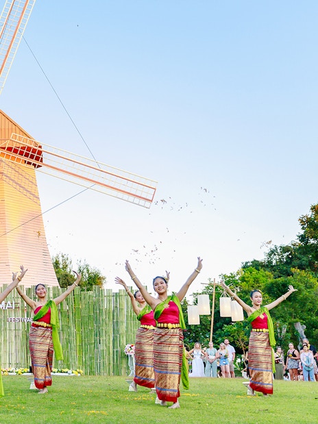 Thai dancers in traditional attire performing at Chiang Mai Sky Lanterns Festival.