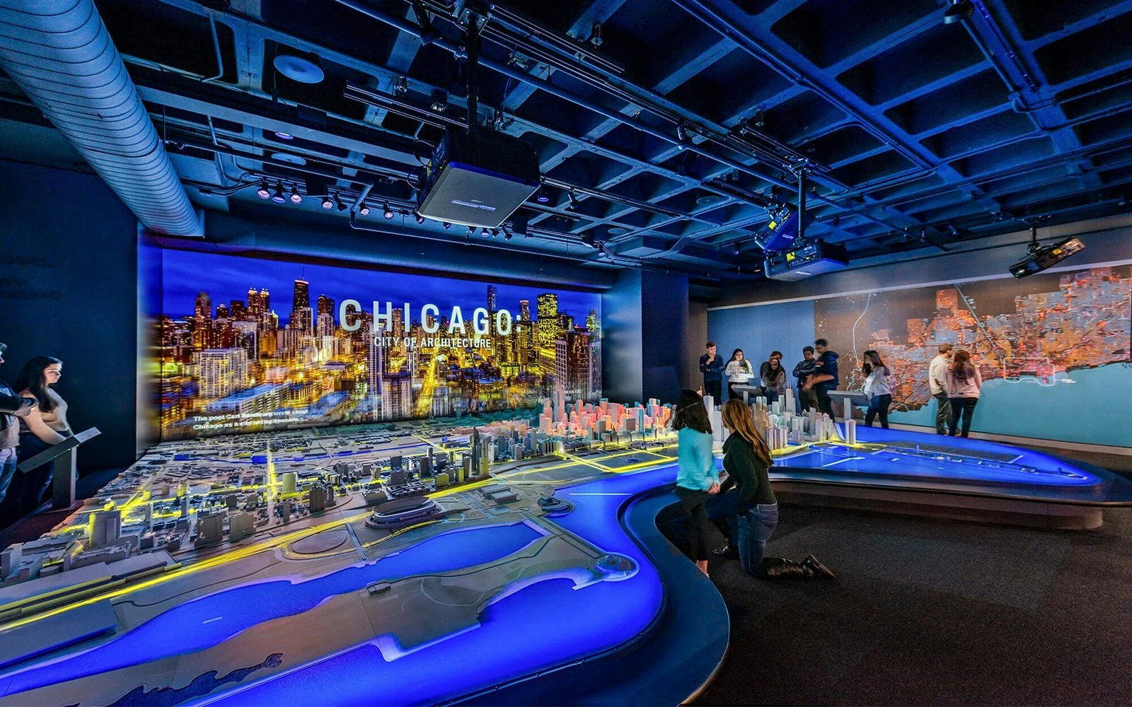 Guests exploring a detailed Chicago city model at the Chicago Architectural Center.
