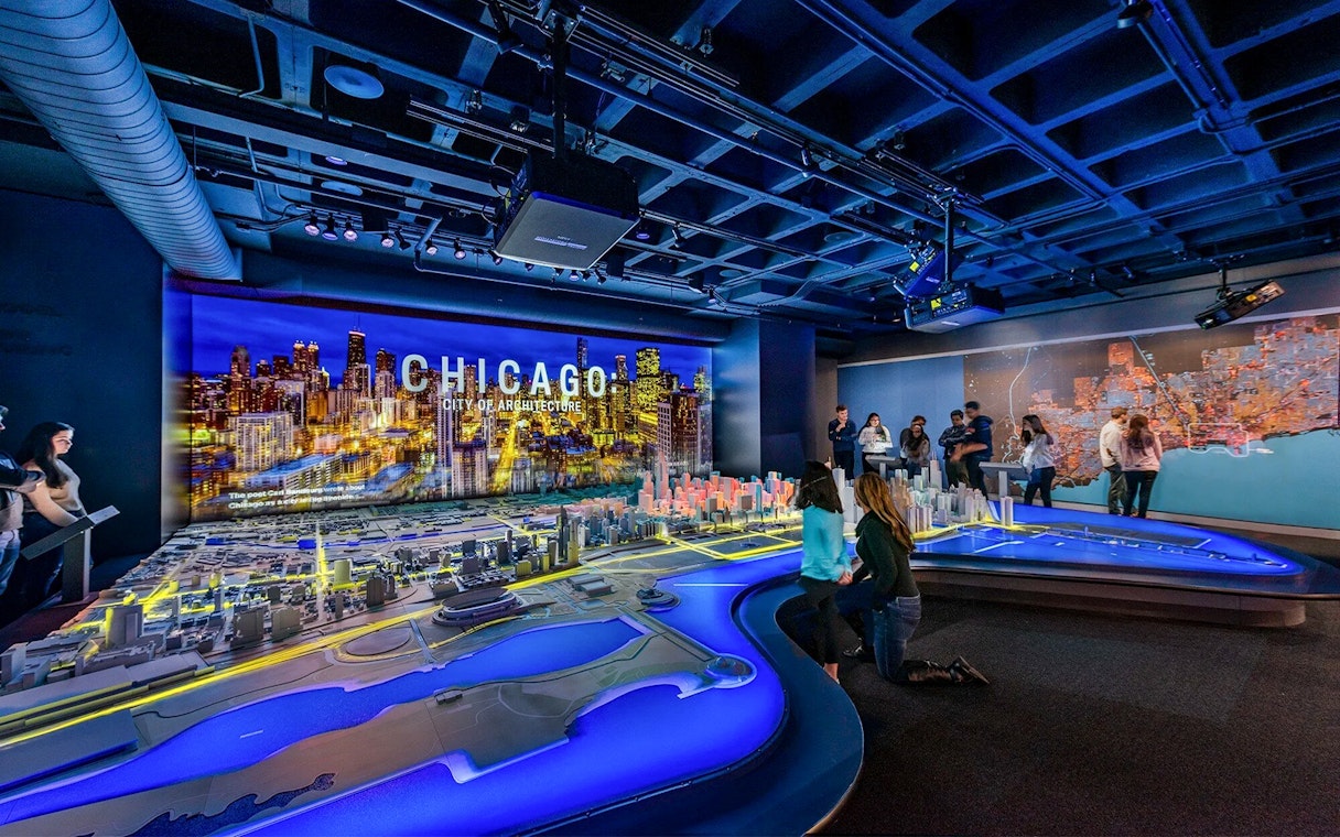 Guests exploring a detailed Chicago city model at the Chicago Architectural Center.