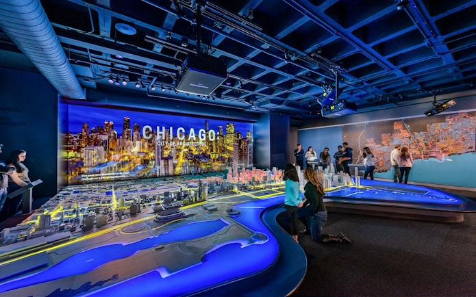 Guests exploring a detailed Chicago city model at the Chicago Architectural Center.