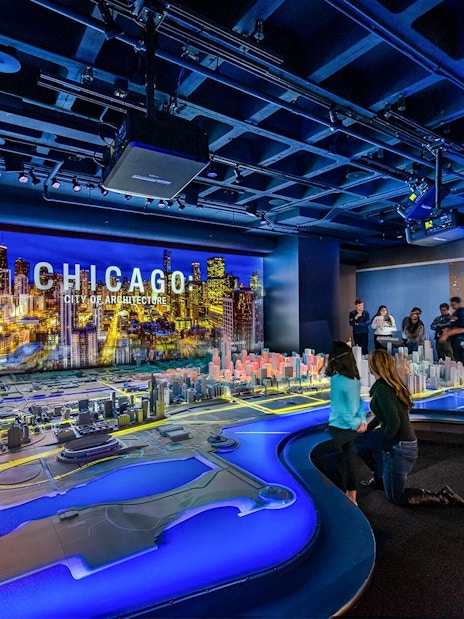 Guests exploring a detailed Chicago city model at the Chicago Architectural Center.