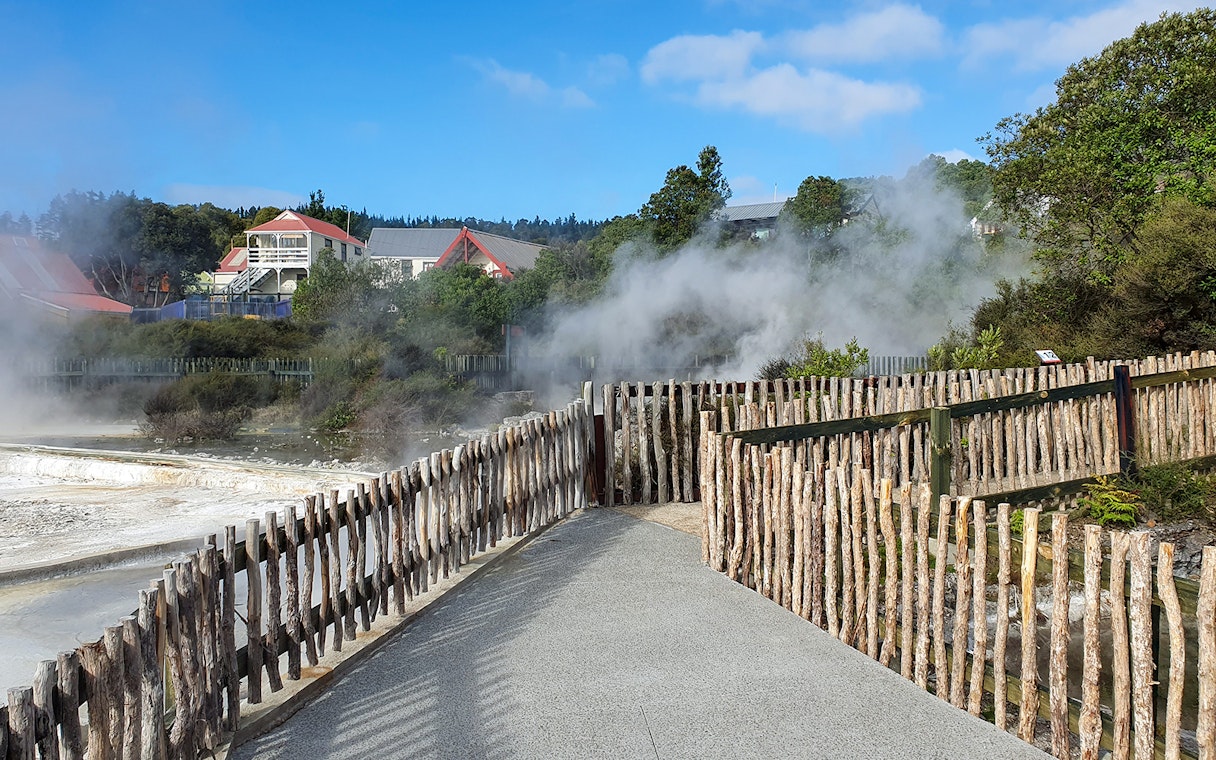 Pathway through geothermal steam at Whakarewarewa Living Maori Village, New Zealand.