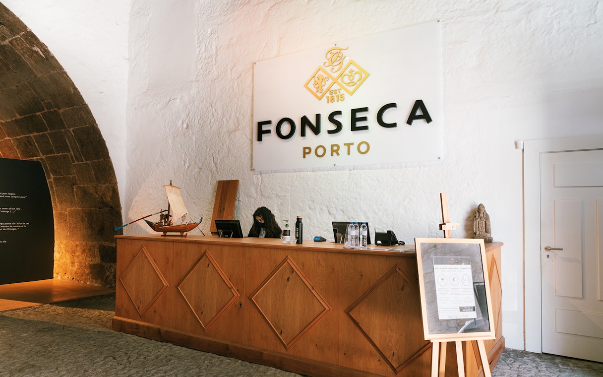 Fonseca Porto wine cellar entrance with reception desk and signage.