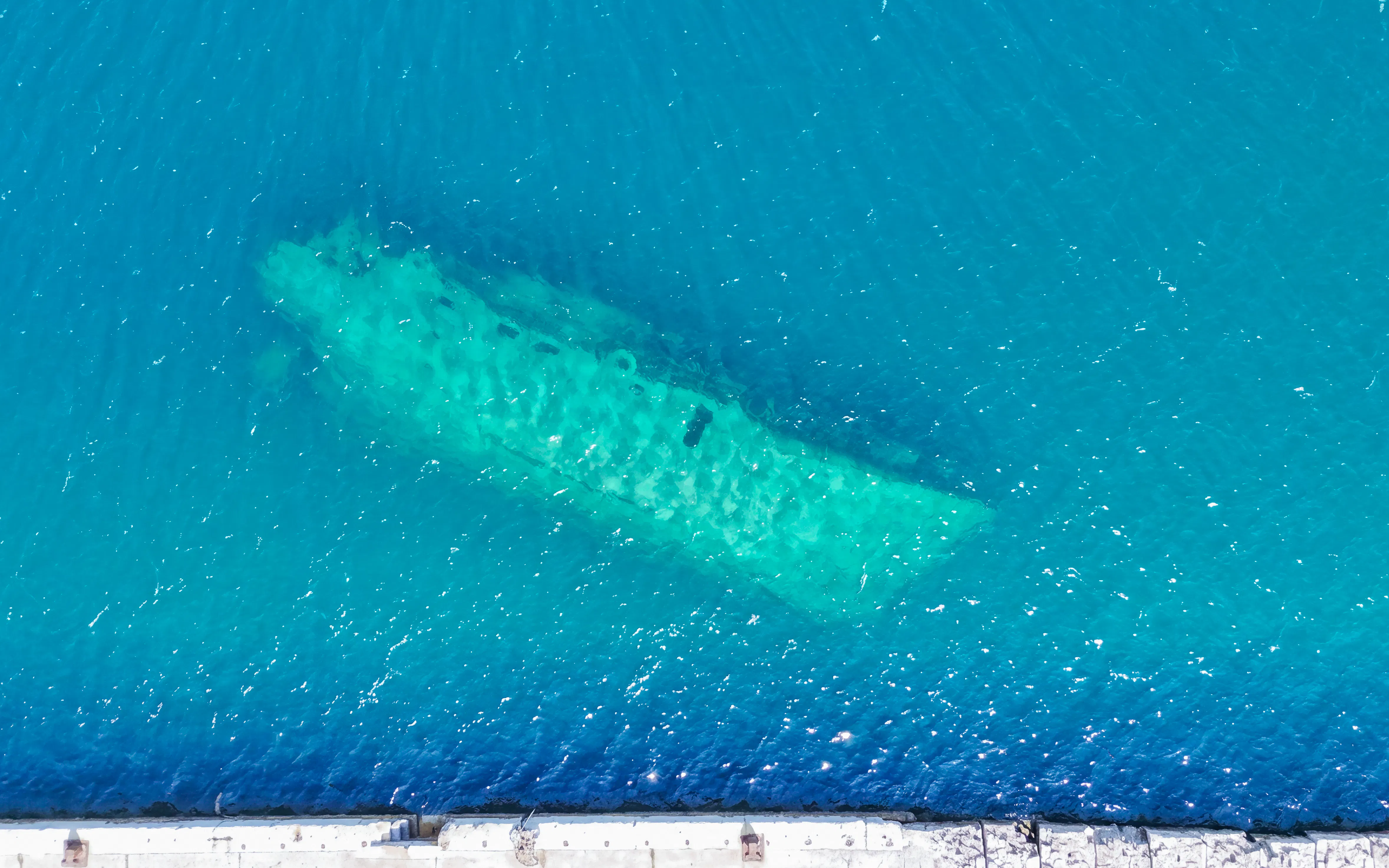Submerged shipwreck in clear waters near Fažana, Brijuni Islands tour.