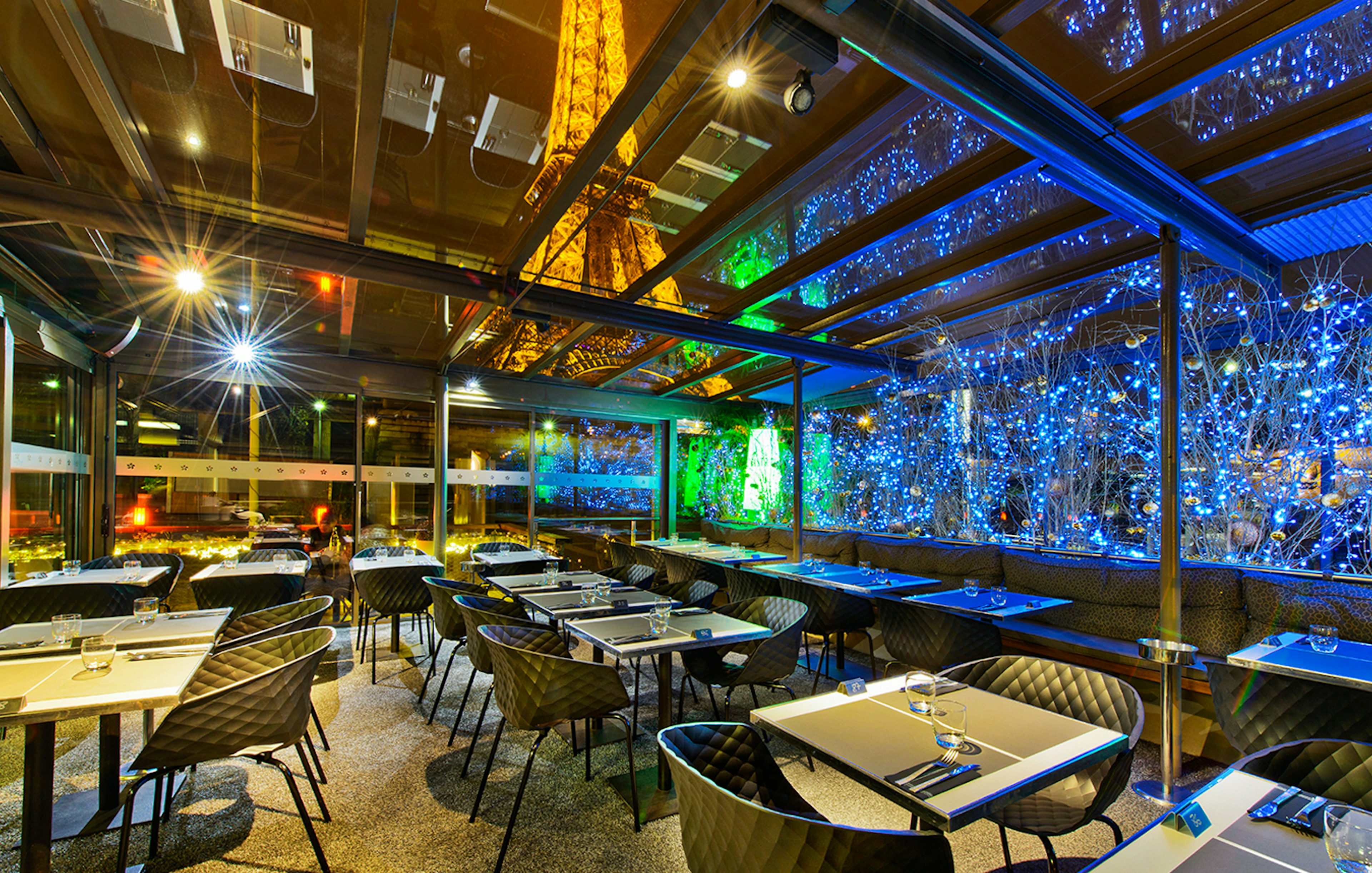 Dining area at Le Bistro Parisien with Eiffel Tower view, Paris.