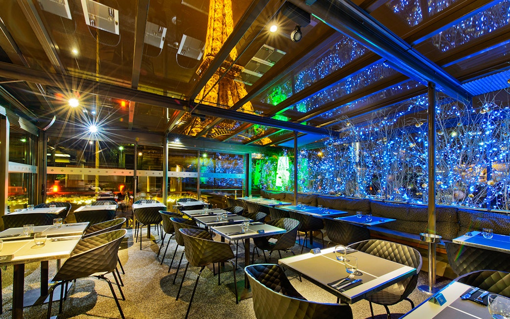 Dining area at Le Bistro Parisien with Eiffel Tower view, Paris.