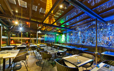 Dining area at Le Bistro Parisien with Eiffel Tower view, Paris.