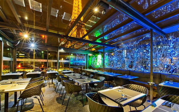 Dining area at Le Bistro Parisien with Eiffel Tower view, Paris.