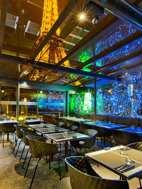 Dining area at Le Bistro Parisien with Eiffel Tower view, Paris.