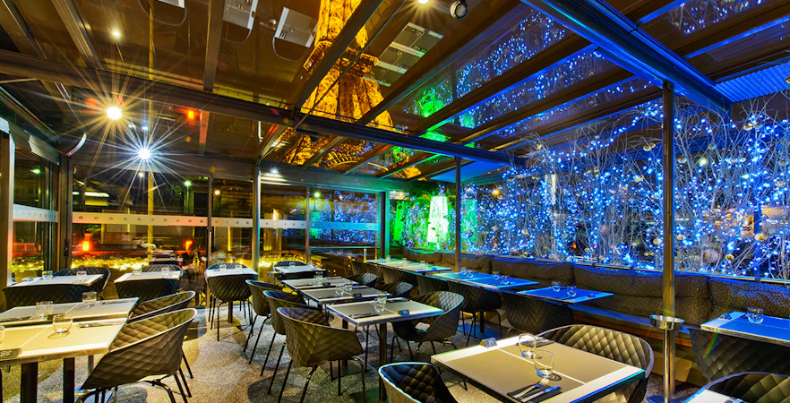 Dining area at Le Bistro Parisien with Eiffel Tower view, Paris.