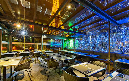 Dining area at Le Bistro Parisien with Eiffel Tower view, Paris.