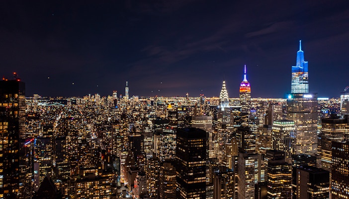 SUMMIT One Vanderbilt illuminated at night with city skyline views, New York City.