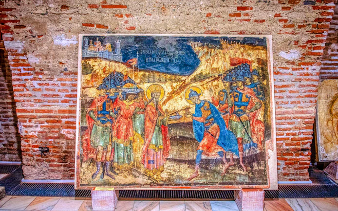 Fresco inside Mogosoaia Palace, Romania depicting historical figures and scenes.