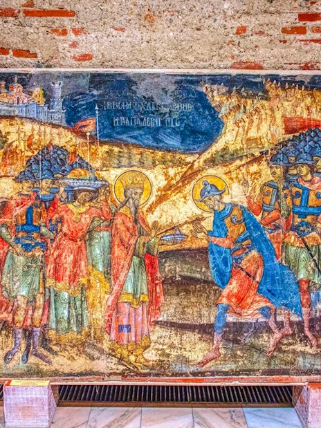 Fresco inside Mogosoaia Palace, Romania depicting historical figures and scenes.