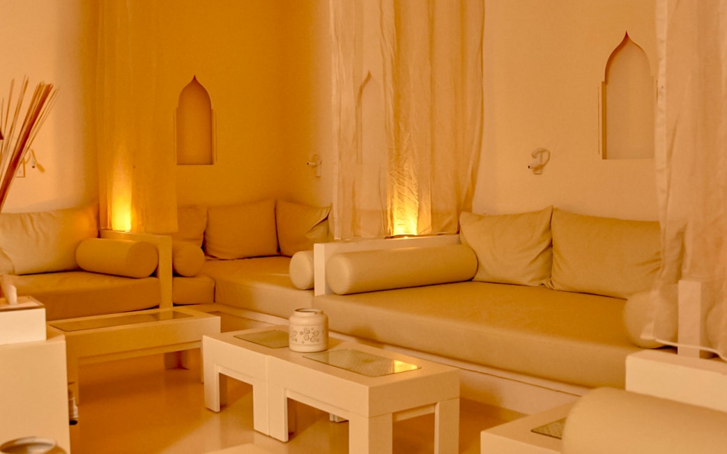 Cozy relaxation area at Mandala Day Spa with soft lighting and comfortable seating.