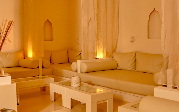 Cozy relaxation area at Mandala Day Spa with soft lighting and comfortable seating.