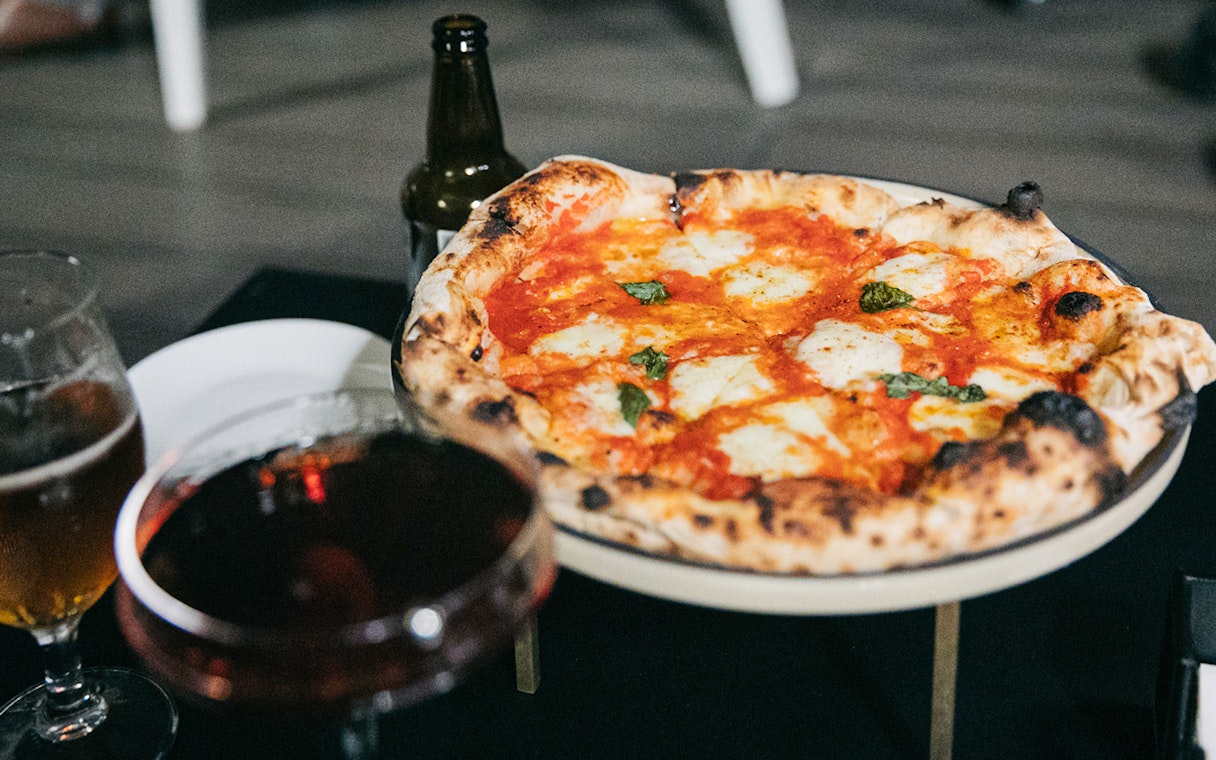 Pizza with drinks on Trastevere Food Tour in Rome.
