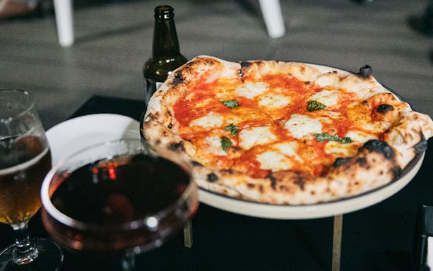 Pizza with drinks on Trastevere Food Tour in Rome.