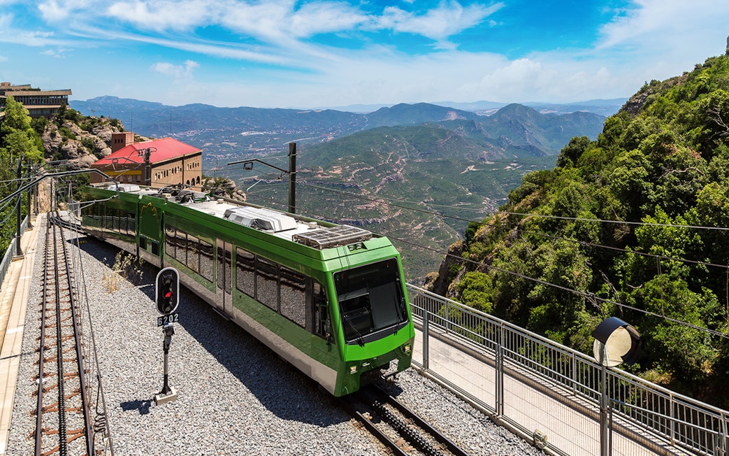 Train journey through scenic Montserrat mountains, Spain.