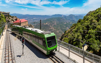 Train journey through scenic Montserrat mountains, Spain.