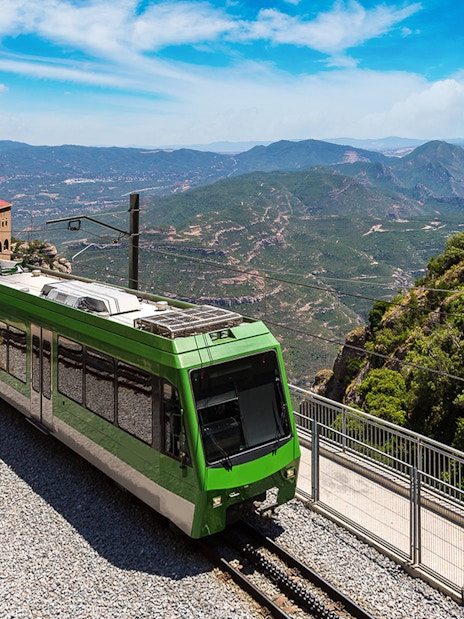 Train journey through scenic Montserrat mountains, Spain.