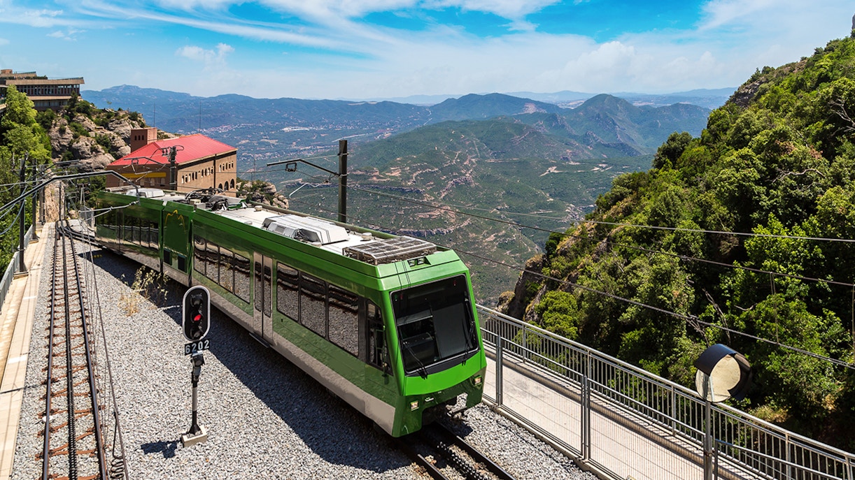Train journey through scenic Montserrat mountains, Spain.