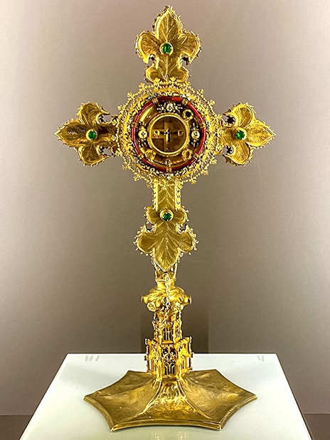 Golden cross with intricate design at St. George's Castle Church.