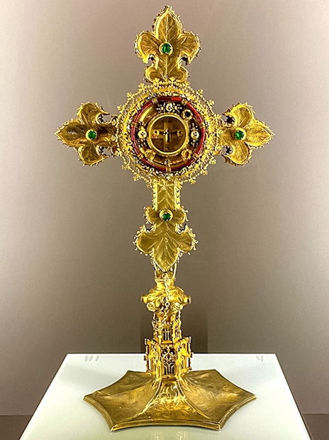 Golden cross with intricate design at St. George's Castle Church.