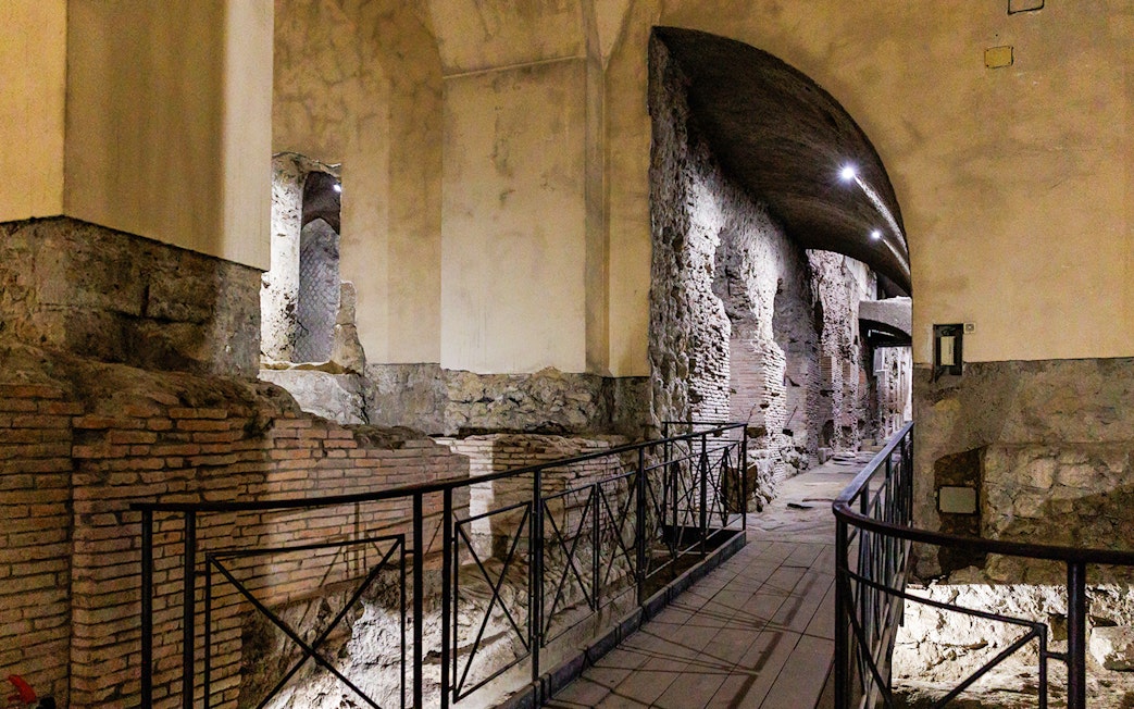 Neapolis Sotterrata ancient stone walls and arches in underground passage.