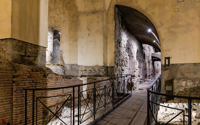 Neapolis Sotterrata ancient stone walls and arches in underground passage.