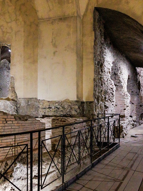 Neapolis Sotterrata ancient stone walls and arches in underground passage.